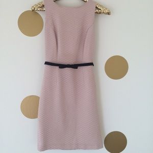 Pink dress with black lace in back.